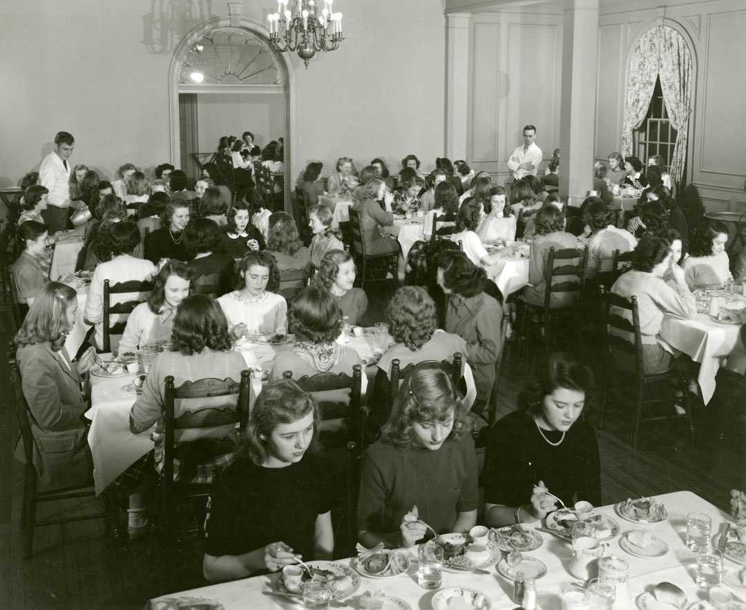 A dining room filled with young women sitting down for a meal.