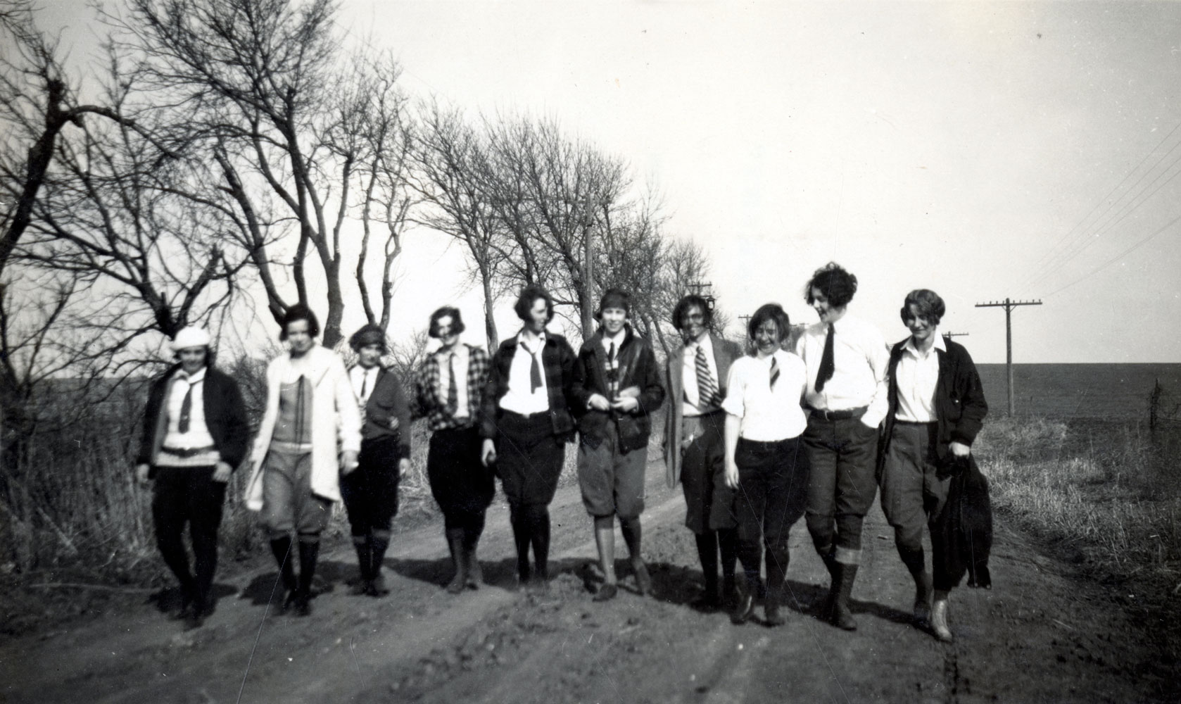 A black and white image of a group of women walking down a path