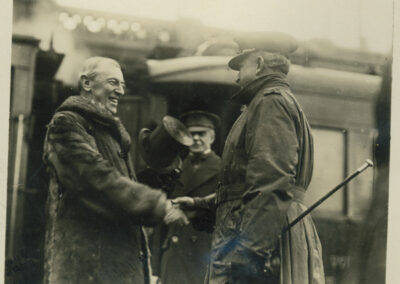 A black and white photograph of Wilson shaking hands with a military official
