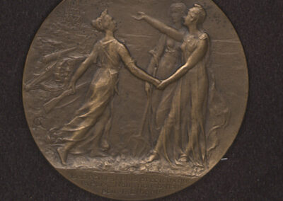 Color photograph of a brass medal on a dark background